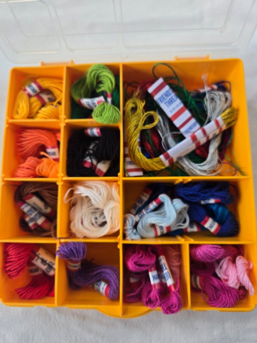 Lidded Bin of multicolored friendship bracelet thread